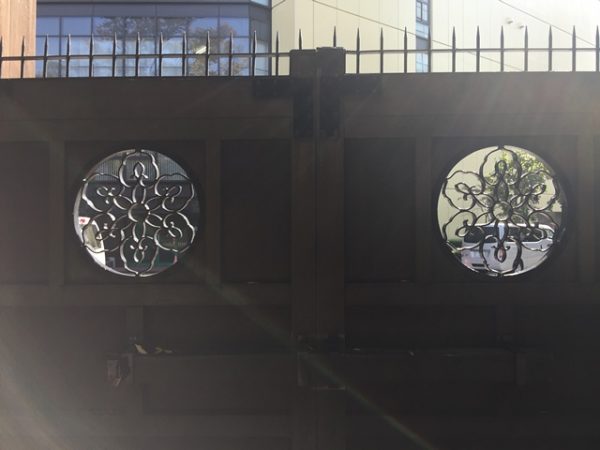 Metropolitan Gardens : 東京都故園, Japanese Culture, Circular metal work with ancient Japanese family crest on one of the wooden gates just outside of Koishikawa Korakuen gardens.