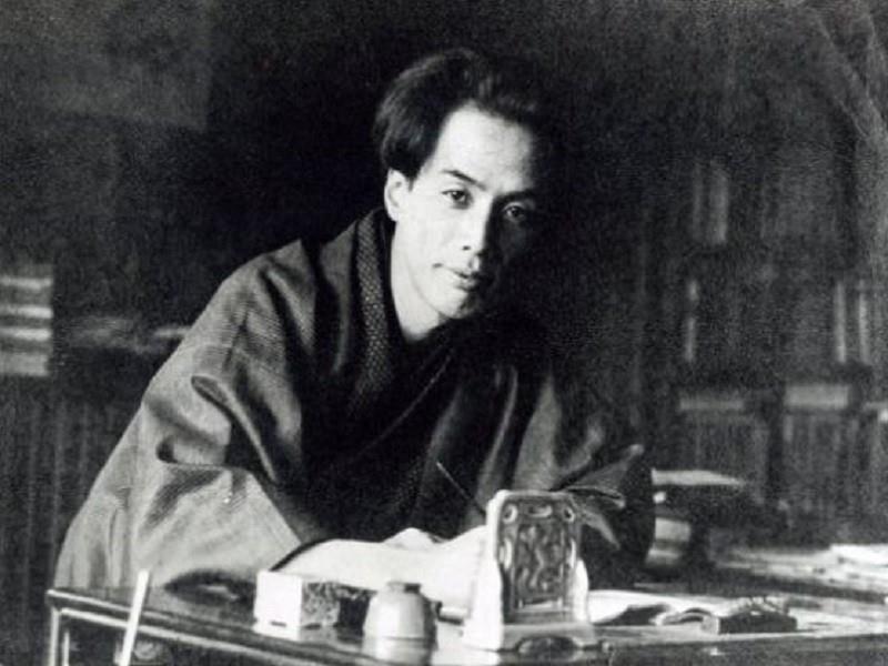 Japanese Culture, Tokyo Fukagawa Literary Horror Sites, Tokyo Fukagawa Literary Horror, A Japanese man in an old black and white photo is wearing a kimono and is sitting down in a study about to write with ink and a brush.