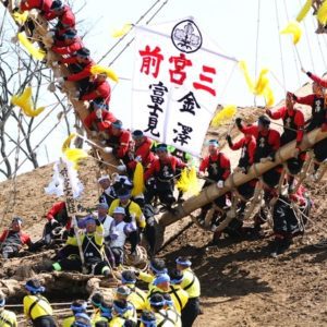 Men riding a log down the mountainside in the Onbashira festival in Nagano.