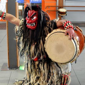 Namahage character beating a taiko drum. Japanese Culture, December in Japan