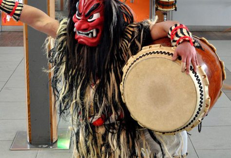 Namahage character beating a taiko drum. Japanese Culture, December in Japan