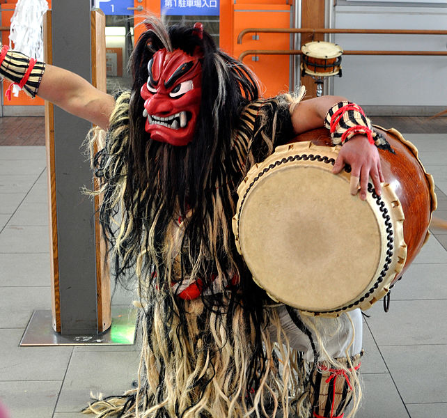 Namahage character beating a taiko drum. Japanese Culture, December in Japan