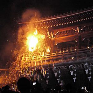 Fire and sparks rain down from the temple roof area.