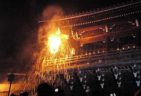 Fire and sparks rain down from the temple roof area.