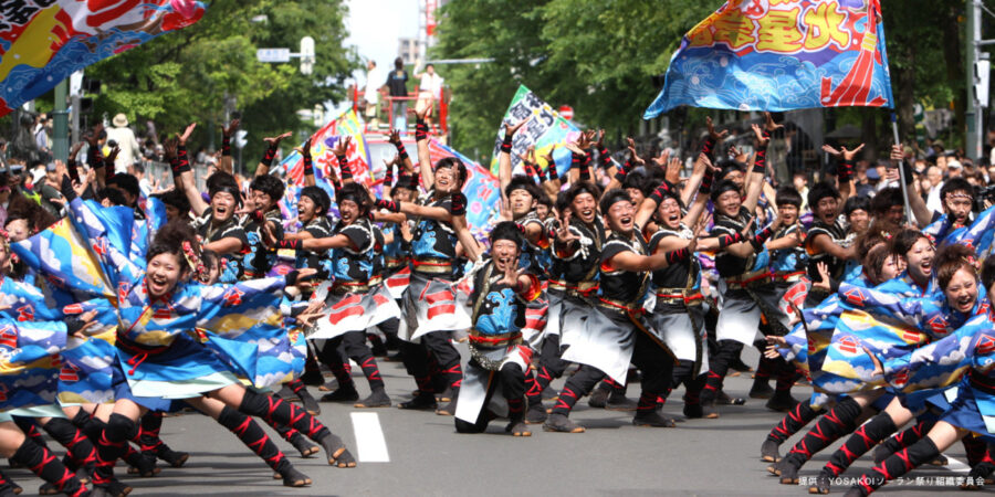 YOSAKOI Soran Festival in Sapporo Dancers Posing for a Group Photograph. They are all wearing blue dancing yukatas.