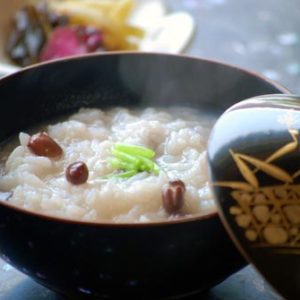 Japanese Culture, Little New Year, Azuchi red beans in a black lacquered with gold inlaid pictures rice bowl with a gold bowl containing kimuchi in the background.