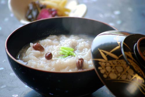 Japanese Culture, Little New Year, Azuchi red beans in a black lacquered with gold inlaid pictures rice bowl with a gold bowl containing kimuchi in the background.