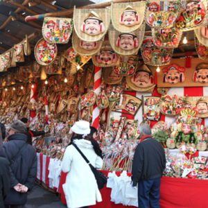 People walking along the store way with images of Ebisu going to the festival at Imayama Ebisu Shrine in Osaka.