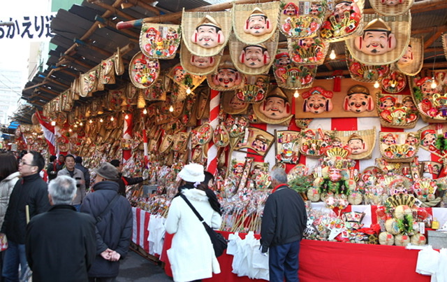 People walking along the store way with images of Ebisu going to the festival at Imayama Ebisu Shrine in Osaka.