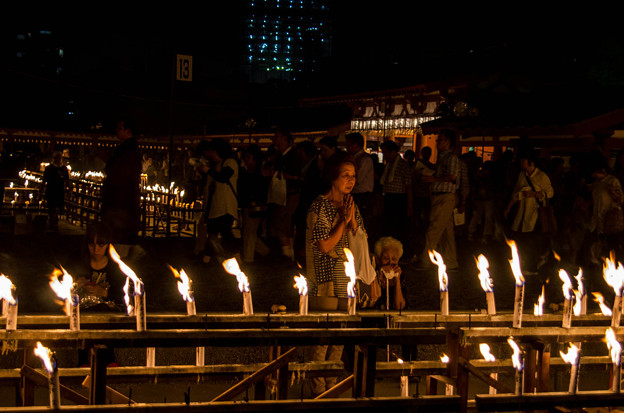 Japanese Culture, Japan in August, Bon Festival, People walking in a dark room lit by candles.