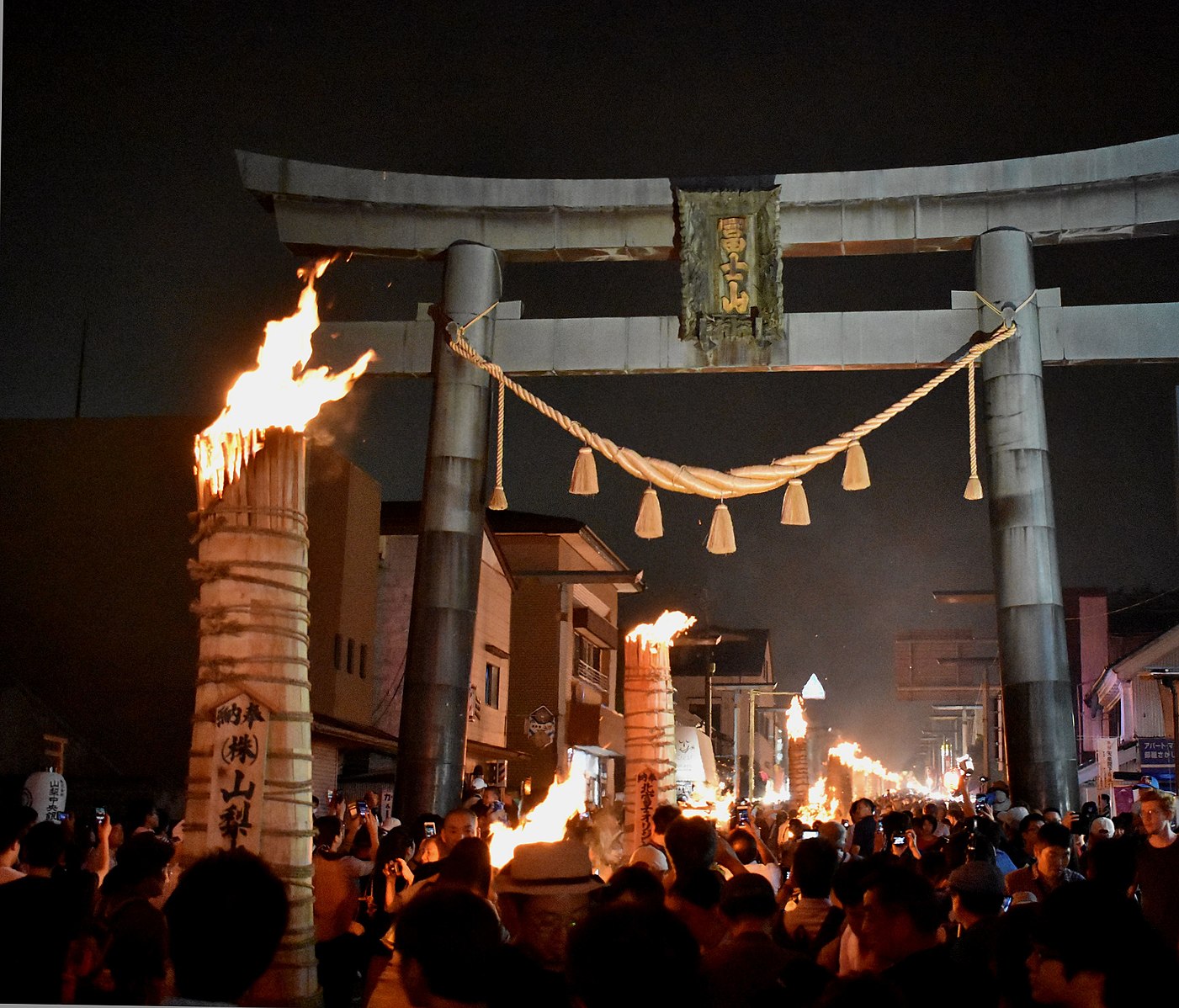 Japanese Culture, Giant three meter tall pine wood torches ablaze in front of FujiYoshida Sengen Shrine.