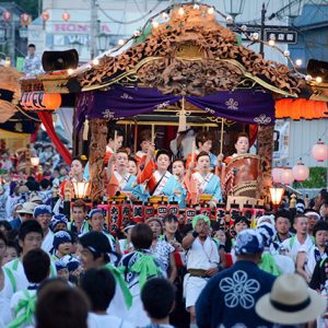 People carrying a mikoshi full of people during Hassaku festival.