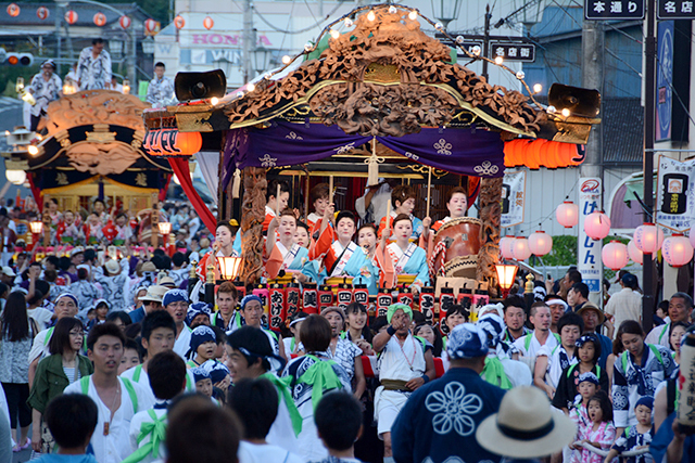 People carrying a mikoshi full of people during Hassaku festival.